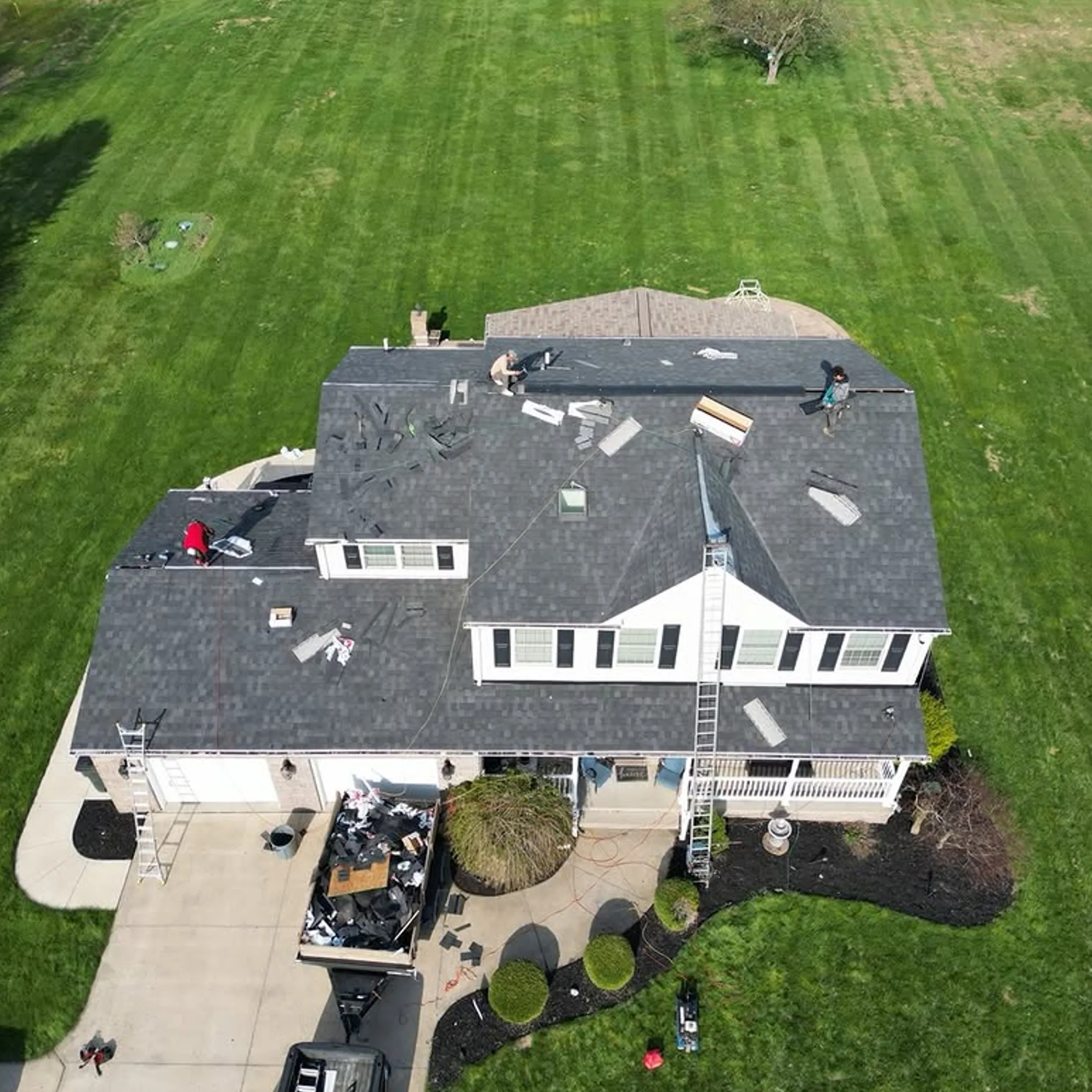 workers repairing roof and gutters