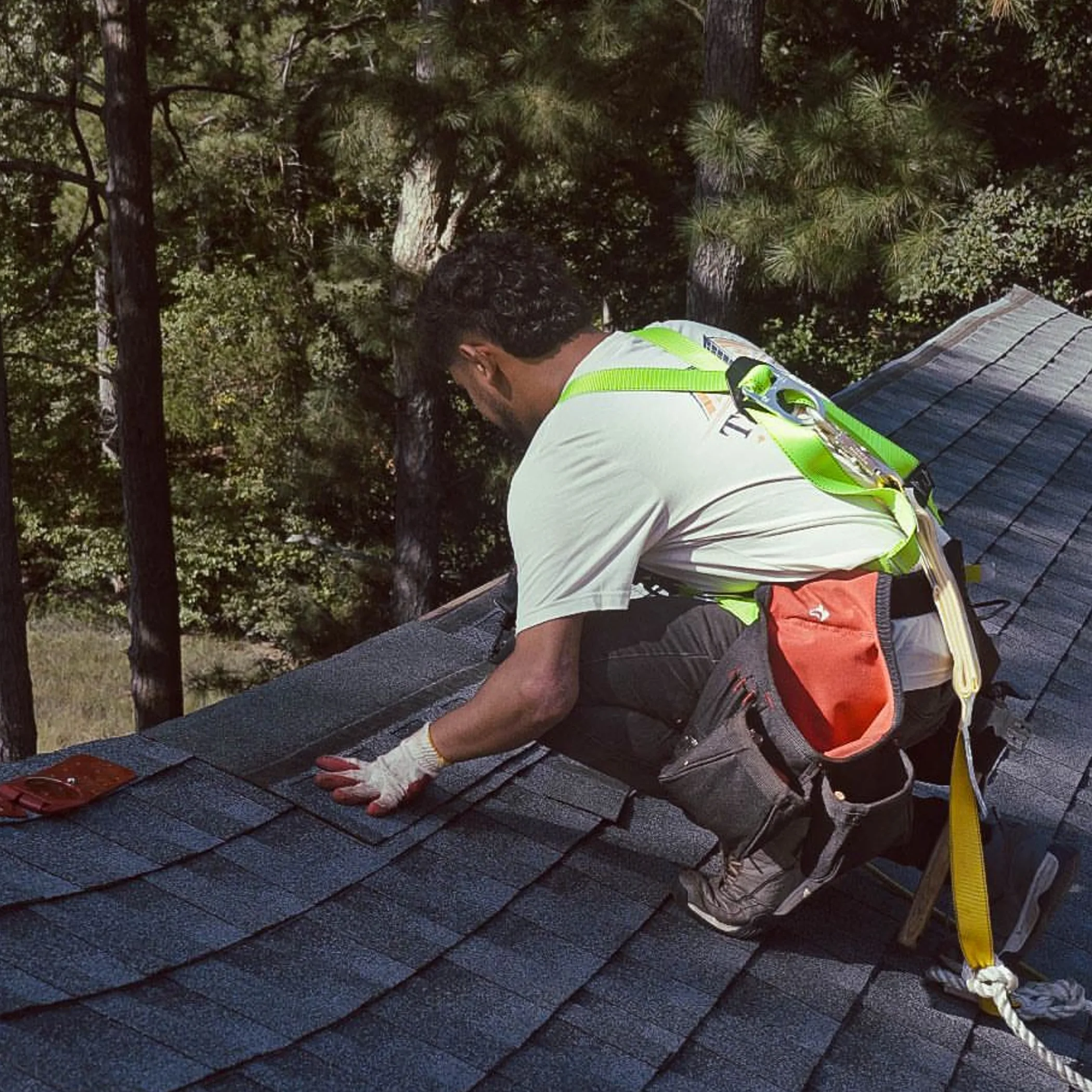 roofer performing roof maintenance